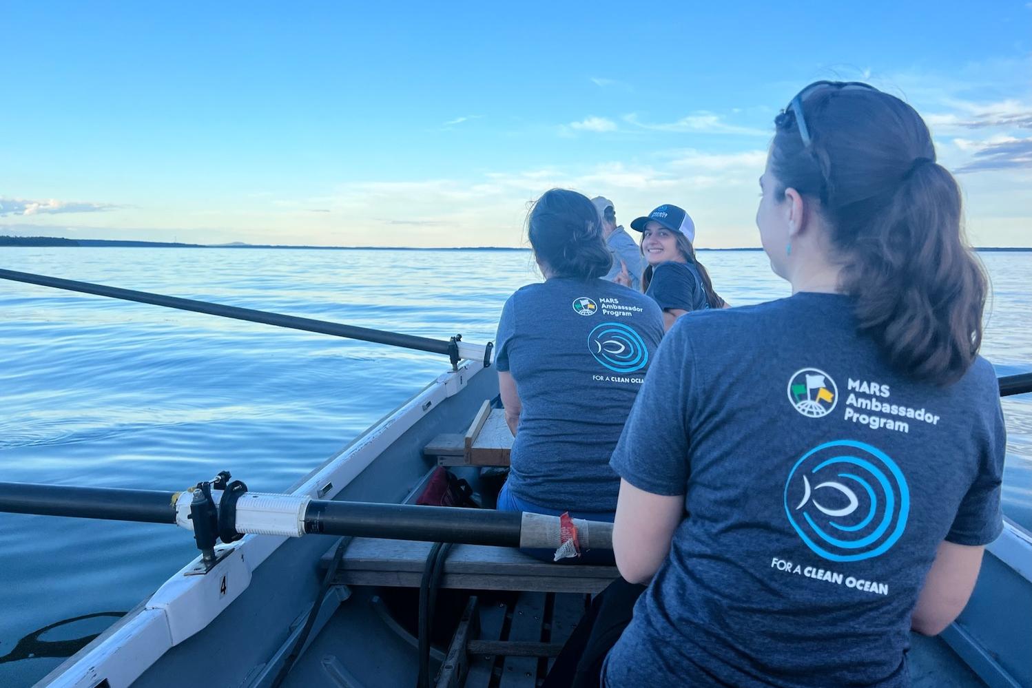 Mars employees on boat - volunteering to remove marine debris